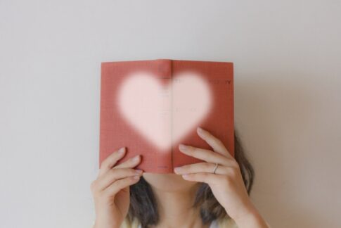 heartの本を持つ女性